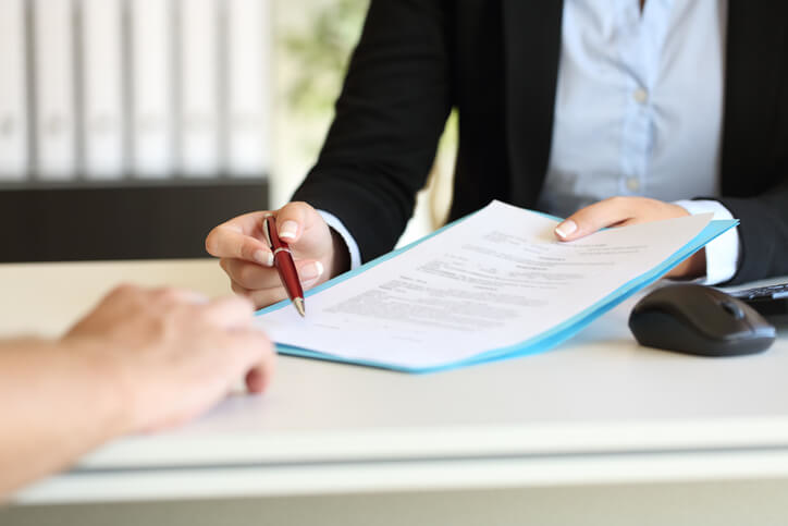 Man presenting forms to a client to be signed